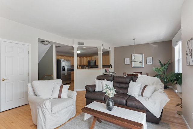 67 Pearl St Unit 8, Essex Junction, VT 05452 - living area featuring ornate columns and light wood-style floors