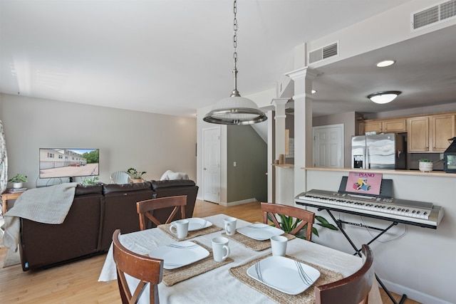 67 Pearl St Unit 8, Essex Junction, VT 05452 - dining area featuring ornate columns and light wood-style floors