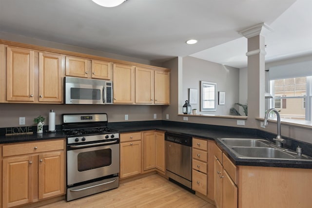 67 Pearl St Unit 8, Essex Junction, VT 05452 - kitchen featuring appliances with stainless steel finishes, decorative columns, light wood finished floors, dark countertops, and recessed lighting