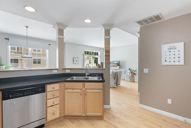 67 Pearl St Unit 8, Essex Junction, VT 05452 - kitchen with stainless steel dishwasher, light wood-style floors, light brown cabinetry, dark countertops, and decorative columns