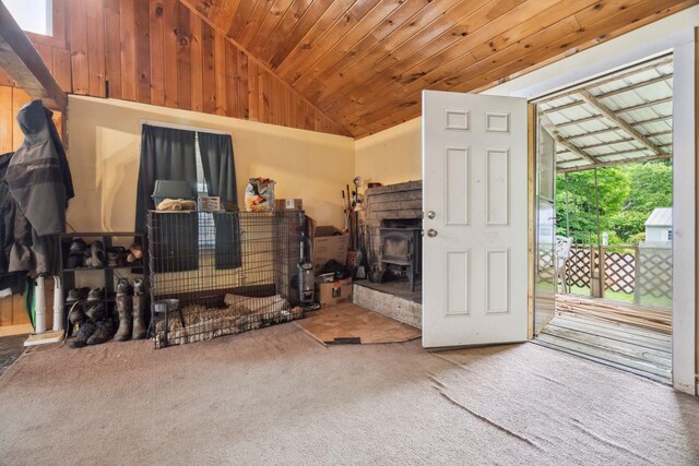 11 Providence Ave, Claremont, NH 03743 - carpeted living room with vaulted ceiling, a wood stove, and wood ceiling