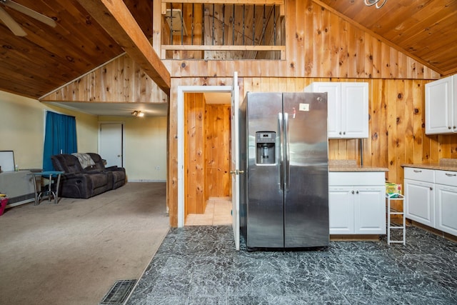 11 Providence Ave, Claremont, NH 03743 - kitchen with stainless steel refrigerator with ice dispenser, wooden ceiling, wood walls, white cabinetry, and open floor plan