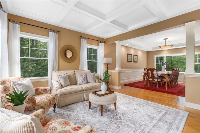 74 Settlers Ct, Bedford, NH 03110 - living area with ornate columns, light wood-type flooring, beam ceiling, wainscoting, and coffered ceiling