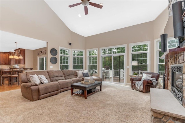 74 Settlers Ct, Bedford, NH 03110 - living room with a ceiling fan, high vaulted ceiling, a fireplace, and light carpet