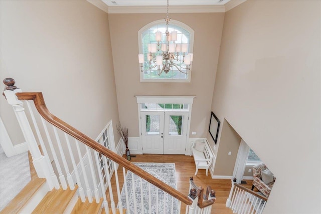 74 Settlers Ct, Bedford, NH 03110 - foyer entrance featuring a chandelier, wood finished floors, a high ceiling, stairway, and crown molding