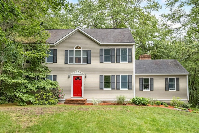 26 Harvard Ln, Bedford, NH 03110 - colonial inspired home featuring a front lawn, roof with shingles, and a chimney