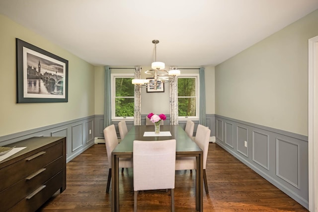 26 Harvard Ln, Bedford, NH 03110 - dining area featuring a chandelier, a decorative wall, wainscoting, dark wood-type flooring, and a baseboard radiator