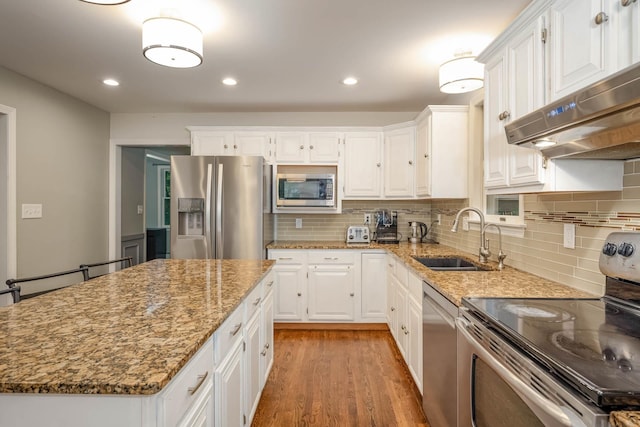 26 Harvard Ln, Bedford, NH 03110 - kitchen with appliances with stainless steel finishes, light stone counters, white cabinetry, under cabinet range hood, and recessed lighting