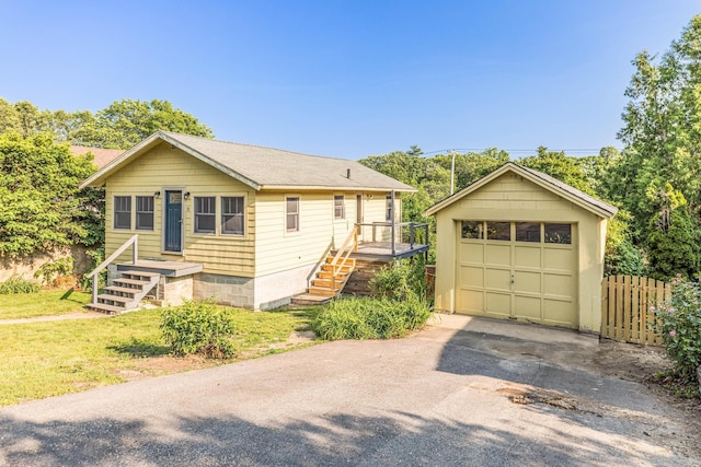 11 Bridge St, Kittery, ME 03904 - view of front facade featuring a detached garage, driveway, and an outbuilding
