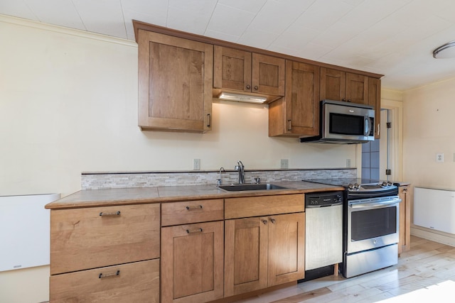 11 Bridge St, Kittery, ME 03904 - kitchen featuring stainless steel appliances, light wood finished floors, brown cabinets, and light countertops