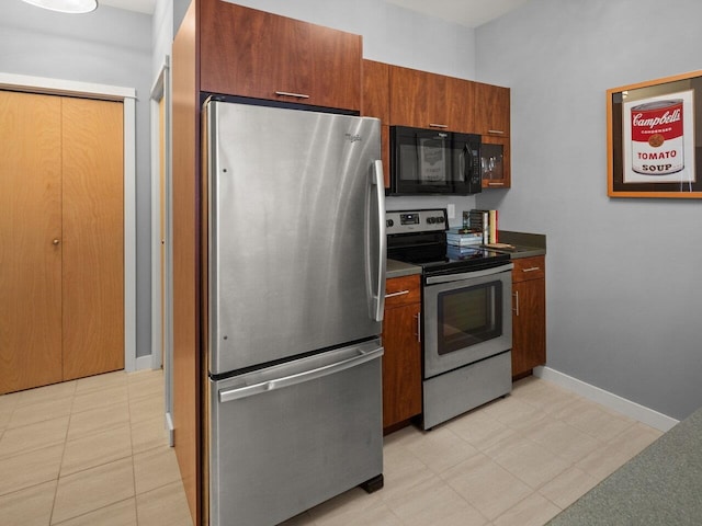 193 Saint Paul St Unit 209, Burlington, VT 05401 - kitchen with stainless steel appliances, dark countertops, and brown cabinetry