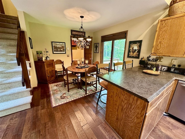 851 German Flats Rd, Fayston, VT 05673 - kitchen featuring dark wood-style flooring, dark countertops, a kitchen bar, a chandelier, and pendant lighting