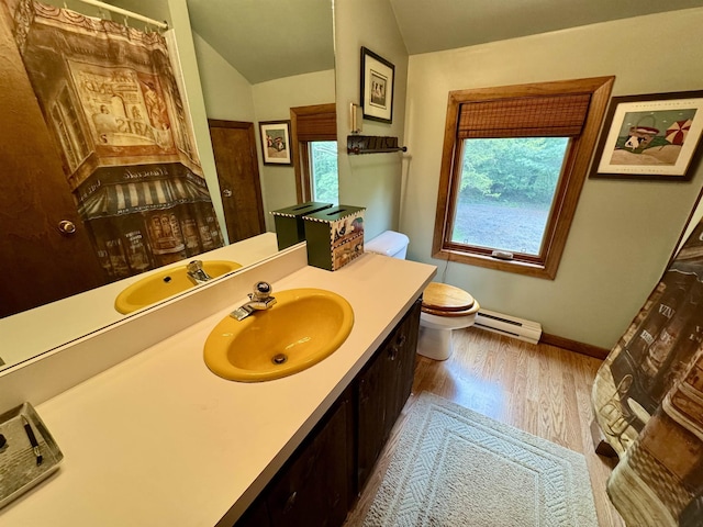 851 German Flats Rd, Fayston, VT 05673 - full bathroom with a baseboard radiator, plenty of natural light, vanity, wood finished floors, and vaulted ceiling
