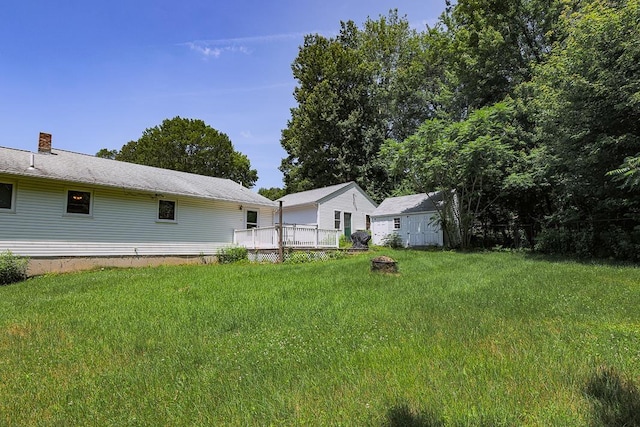 4 Appaloosa Ave, Pelham, NH 03076 - view of green lawn featuring a fire pit and a deck