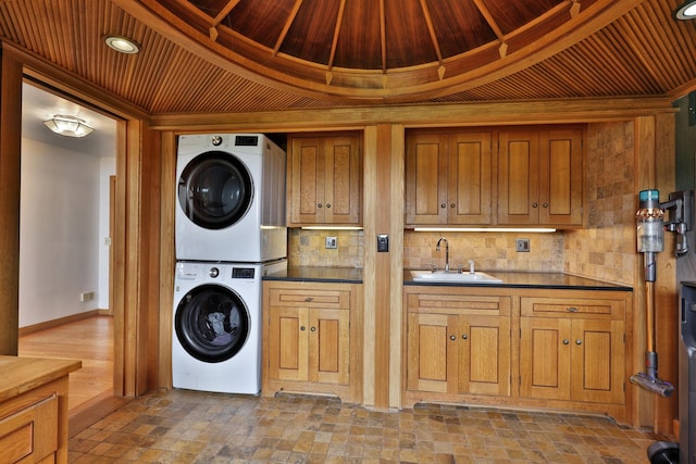 465 Pennell Rd, Chester, VT 05143 - laundry area featuring stacked washing machine and dryer and cabinet space