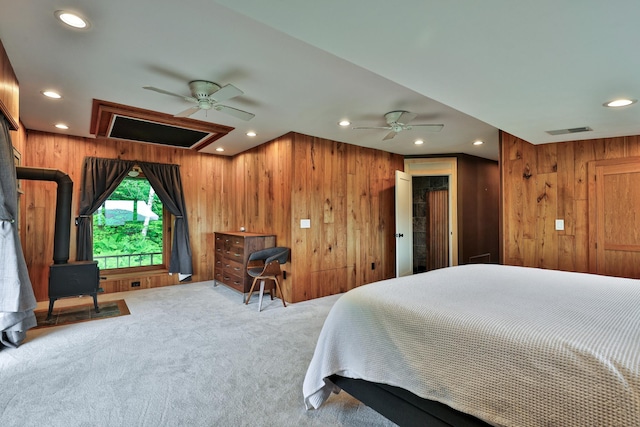 465 Pennell Rd, Chester, VT 05143 - bedroom featuring a wood stove, wooden walls, carpet, and recessed lighting