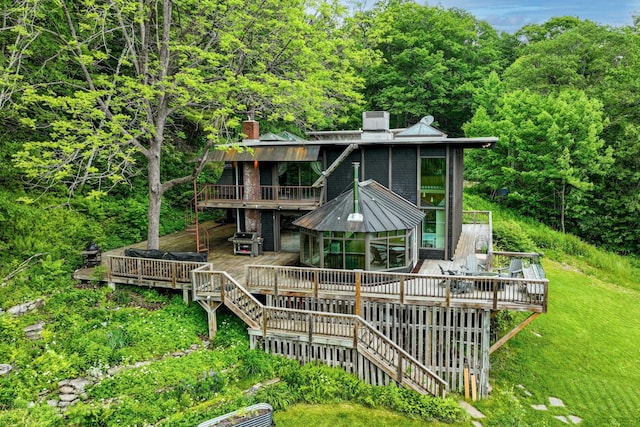 465 Pennell Rd, Chester, VT 05143 - back of house featuring a chimney, a wooden deck, and a view of trees