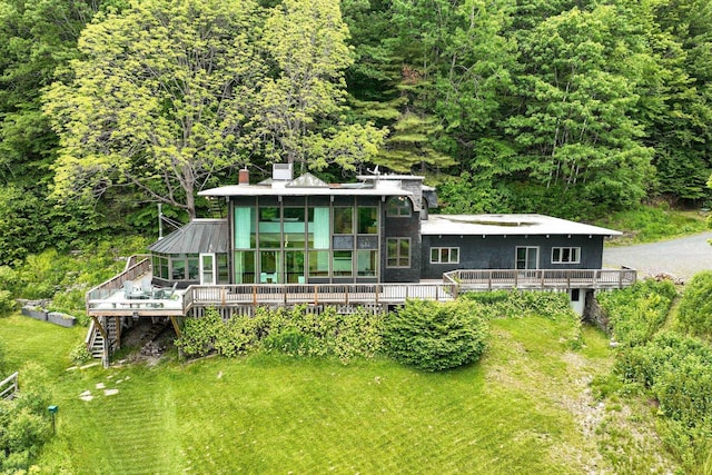 465 Pennell Rd, Chester, VT 05143 - rear view of property featuring a deck, a sunroom, a forest view, and a lawn