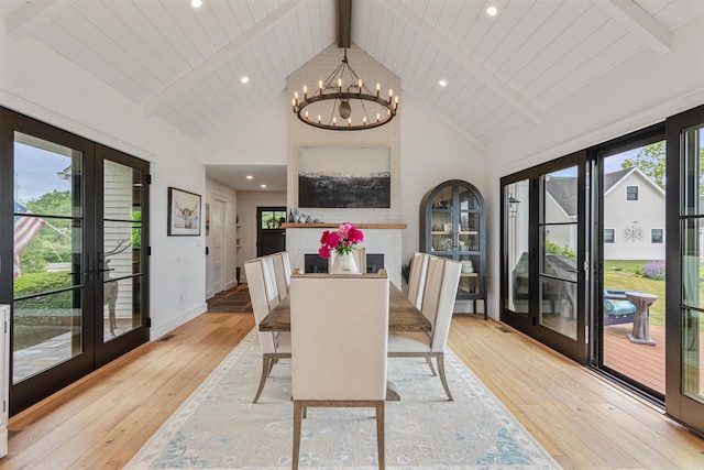 1549 Hinesburg Rd, South Burlington, VT 05403 - dining area featuring french doors, light wood-type flooring, beamed ceiling, a chandelier, and high vaulted ceiling