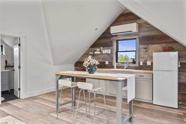 1549 Hinesburg Rd, South Burlington, VT 05403 - bar with freestanding refrigerator, a wall unit AC, light wood-style flooring, lofted ceiling, and wood walls