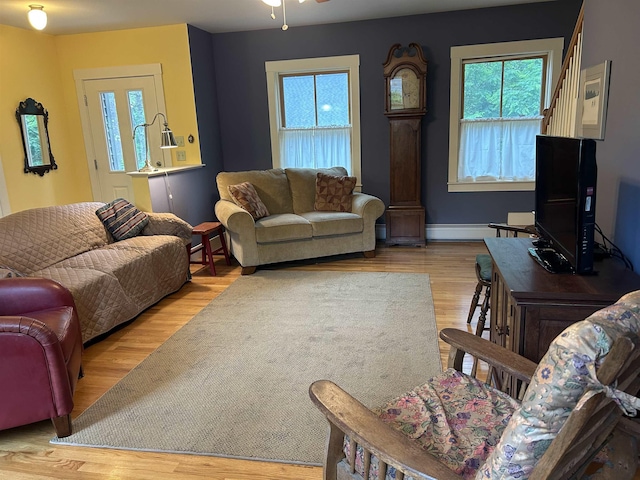 11 Morrison Ave, Meredith, NH 03253 - living room featuring baseboard heating, wood finished floors, and ceiling fan