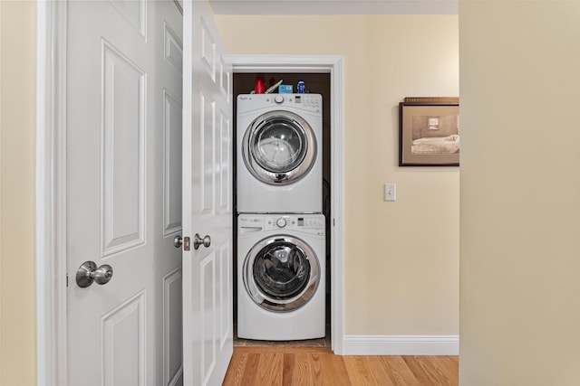 42 Leddy Dr, Epping, NH 03042 - laundry room featuring stacked washer and clothes dryer and light wood-style flooring