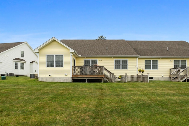 42 Leddy Dr, Epping, NH 03042 - rear view of house with a deck, stairway, a lawn, and a shingled roof