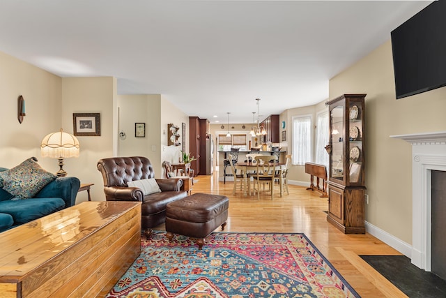 42 Leddy Dr, Epping, NH 03042 - living area with light wood-type flooring and a chandelier