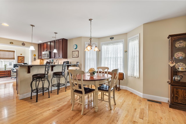 42 Leddy Dr, Epping, NH 03042 - dining area with light wood-type flooring, a chandelier, and recessed lighting