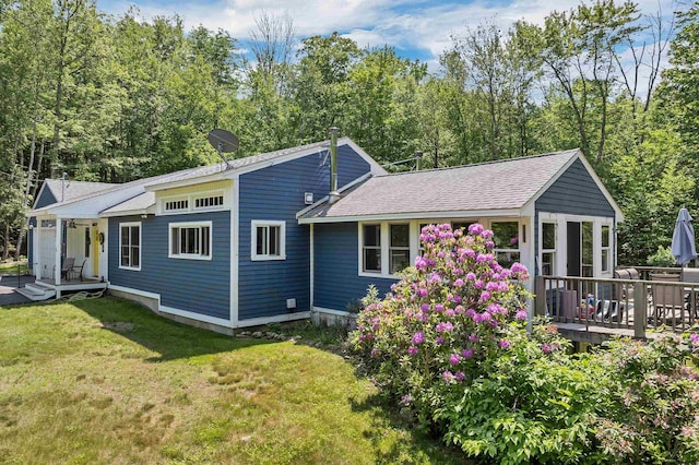 30 Dillon Dr E E, Unit East, Strafford, NH 03884 - back of house with a lawn, a shingled roof, and a wooden deck