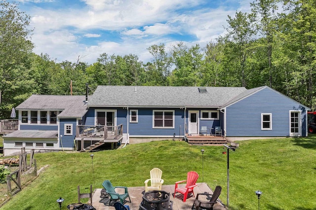 30 Dillon Dr E E, Unit East, Strafford, NH 03884 - rear view of house with a fire pit, a deck, a lawn, and roof with shingles