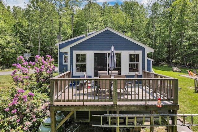 30 Dillon Dr E E, Unit East, Strafford, NH 03884 - rear view of property with a deck, a yard, outdoor dining space, and a forest view