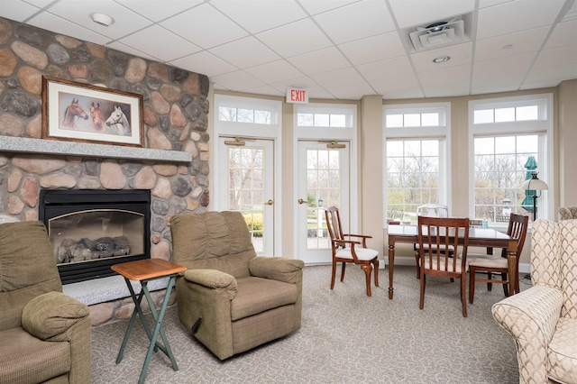 118 Secretariat Way Unit 115, Rochester, NH 03867 - carpeted living area with a paneled ceiling and a stone fireplace