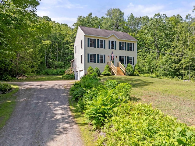 202 Cherry Valley Rd, Alton, NH 03810 - colonial house with a garage, driveway, a view of trees, and a front lawn
