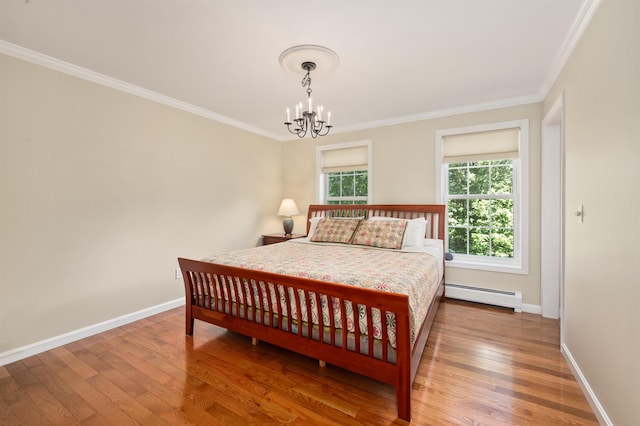 202 Cherry Valley Rd, Alton, NH 03810 - bedroom featuring a baseboard heating unit, a chandelier, wood finished floors, and crown molding