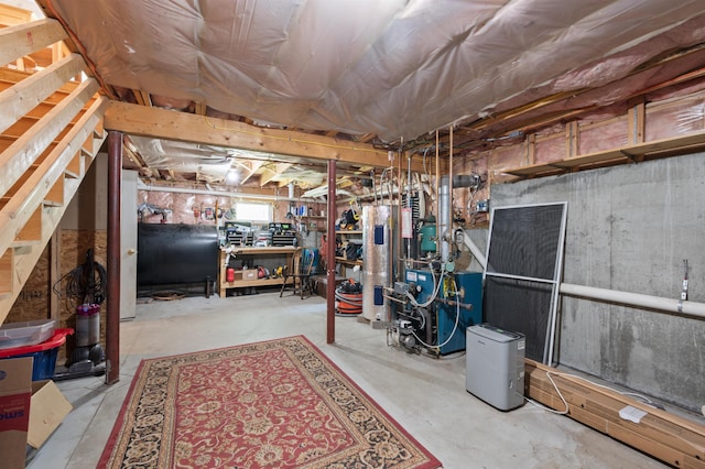 202 Cherry Valley Rd, Alton, NH 03810 - below grade area featuring heating fuel, electric water heater, a workshop area, and a heating unit