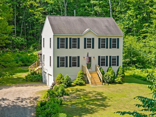 202 Cherry Valley Rd, Alton, NH 03810 - colonial home with driveway, a garage, roof with shingles, a front lawn, and a view of trees