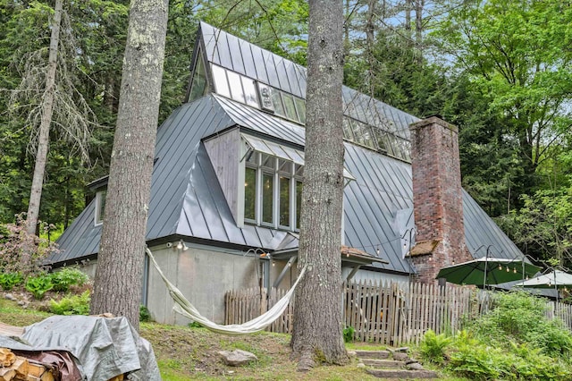 812 Airport Rd, Fayston, VT 05660 - back of property with a standing seam roof, a metal roof, and a chimney