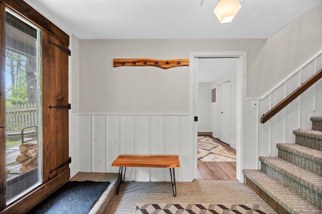 812 Airport Rd, Fayston, VT 05660 - foyer with stairs, a wainscoted wall, a skylight, and wood finished floors