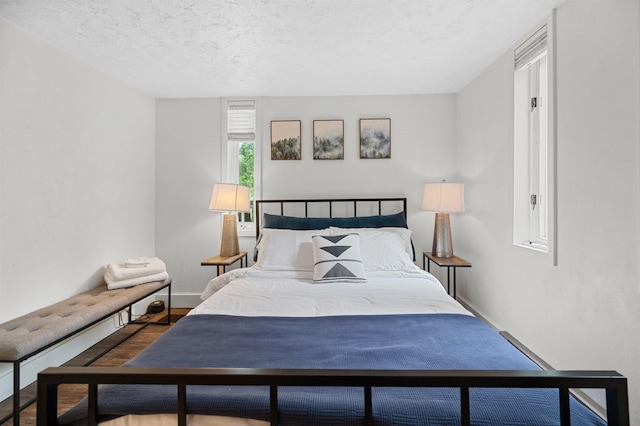 812 Airport Rd, Fayston, VT 05660 - bedroom featuring a textured ceiling and wood finished floors