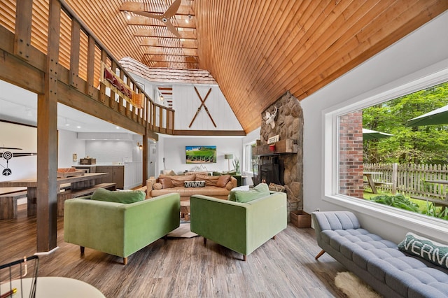 812 Airport Rd, Fayston, VT 05660 - living room with high vaulted ceiling, wood finished floors, wood ceiling, and a fireplace