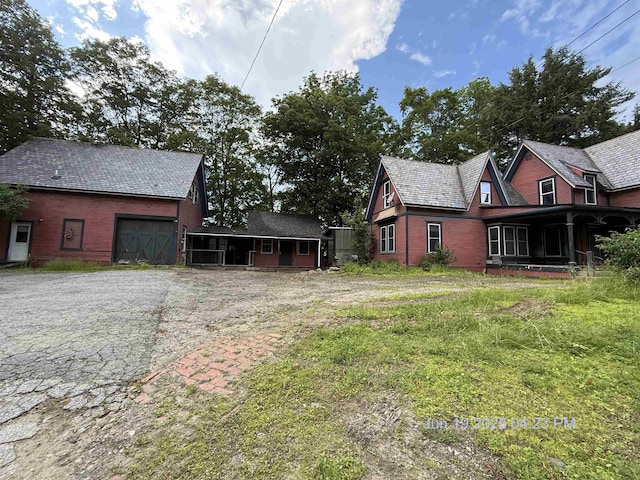 23 S Main St, Randolph, VT 05060 - view of side of property featuring an attached garage and an outdoor structure