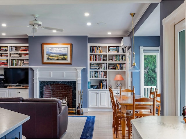 1411 Spear St, South Burlington, VT 05403 - living room with ceiling fan, a wall mounted AC, a high end fireplace, crown molding, and light wood finished floors