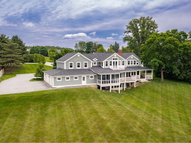 1411 Spear St, South Burlington, VT 05403 - rear view of house with driveway, a yard, a garage, and a sunroom