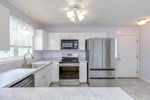 491 Mammoth Rd Unit 7, Londonderry, NH 03053 - kitchen with appliances with stainless steel finishes, light tile patterned flooring, white cabinetry, and light countertops
