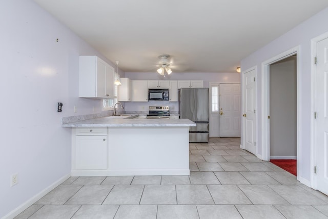 491 Mammoth Rd Unit 7, Londonderry, NH 03053 - kitchen featuring stainless steel appliances, a peninsula, light countertops, a ceiling fan, and white cabinetry