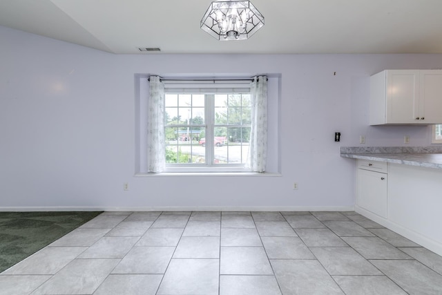 491 Mammoth Rd Unit 7, Londonderry, NH 03053 - unfurnished dining area featuring baseboards and light tile patterned floors