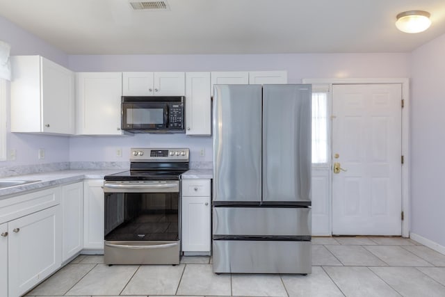 491 Mammoth Rd Unit 7, Londonderry, NH 03053 - kitchen featuring appliances with stainless steel finishes, white cabinets, and light tile patterned floors