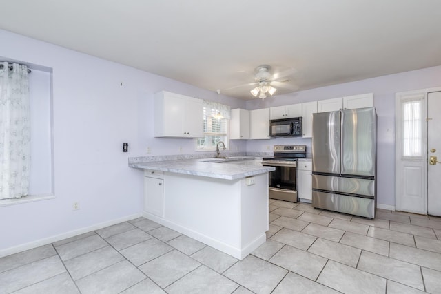 491 Mammoth Rd Unit 7, Londonderry, NH 03053 - kitchen featuring appliances with stainless steel finishes, a peninsula, white cabinetry, light countertops, and ceiling fan