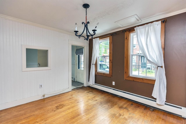 102 W Merrimack St Unit 1, Manchester, NH 03101 - empty room with baseboard heating, crown molding, wood-type flooring, and a chandelier